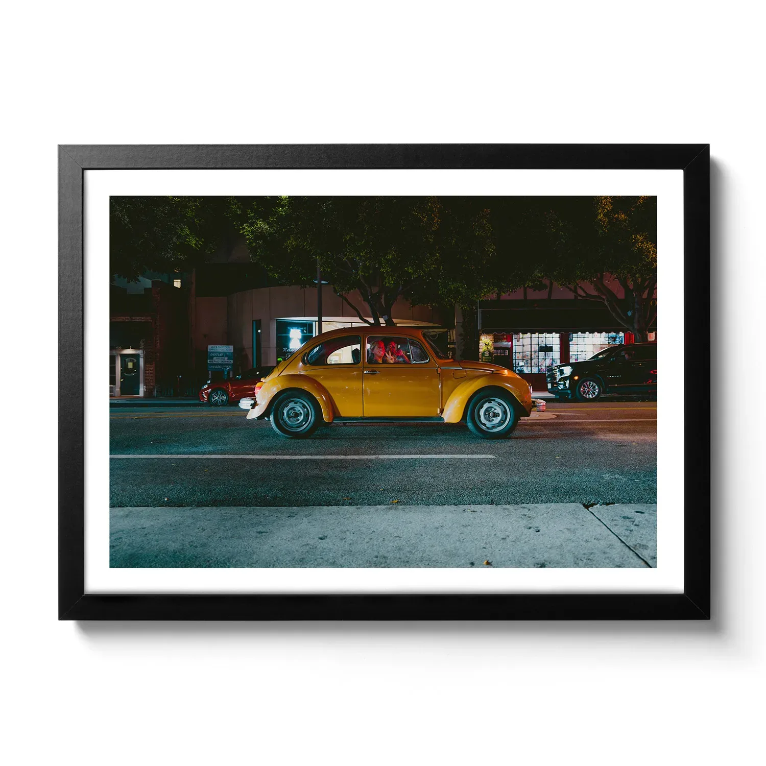 Image of an orange VW Beetle with a woman waving out with the hand gesture "Peace".