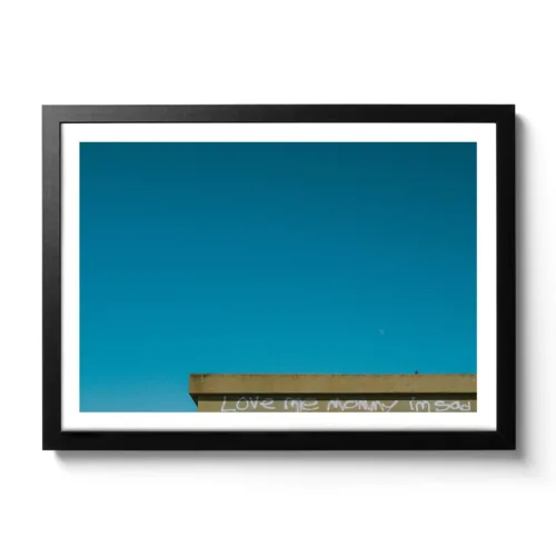 Bildaufnahme eines Daches mit der Aufschrift "Love me Mommy I am sad".