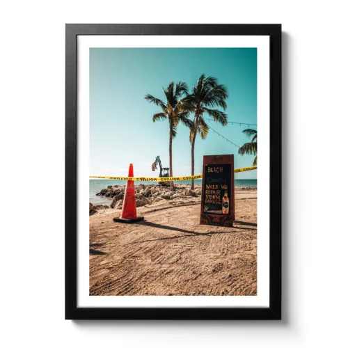 Image showing an excavator on the beach. In front of it is a barrier with a sign saying that the beach is closed but the bar is open.