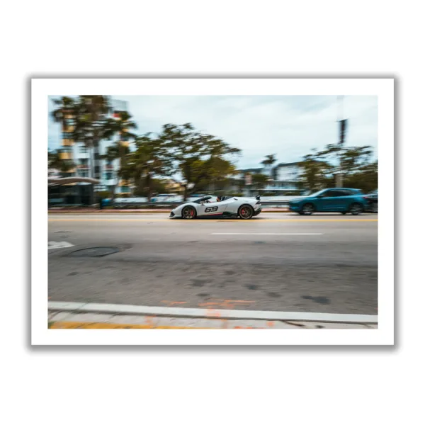 Image of a fast white Lamborghini speeding through Miami. Inscription 69.