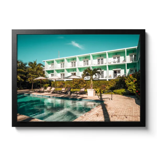 Picture of the pool area of the Grassy Flat Hotel. Blue sky, pool and loungers. Morning view.