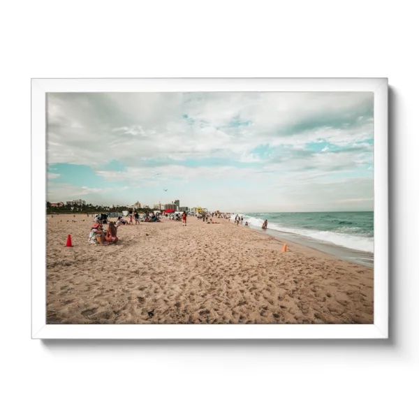 Beach shot of Miami Beach. People chilling on the beach and blue sea